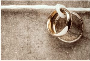 a pair of gold rings tied to a white rope Divorce Investigations 